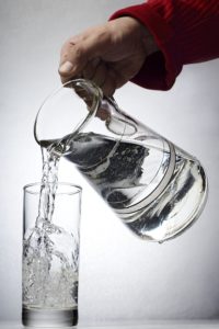 water being poured from the pitcher to the glass